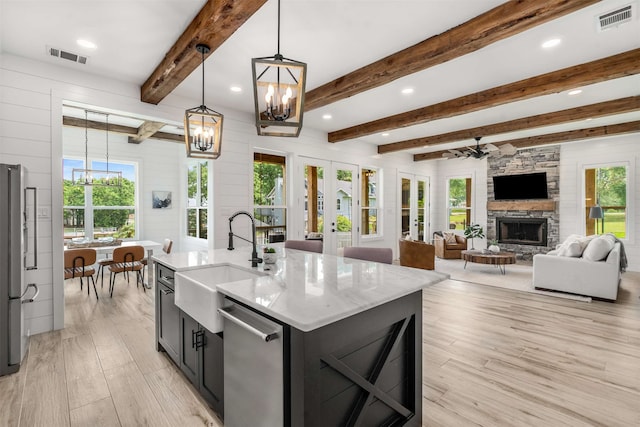 205 Oak Creek Dr, Tool, TX 75143 - kitchen featuring a chandelier, a sink, a stone fireplace, light wood-type flooring, and beamed ceiling