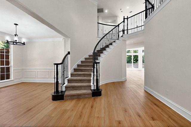 140 Collin Ct, Murphy, TX 75094 - entrance foyer featuring stairway, a chandelier, wood finished floors, crown molding, and wainscoting