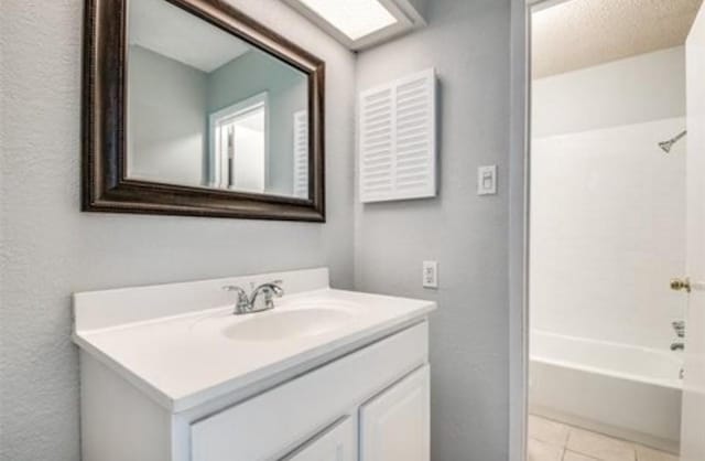 5232 Fleetwood Oaks Ave Unit 216, Dallas, TX 75235 - full bathroom with vanity, washtub / shower combination, and tile patterned floors