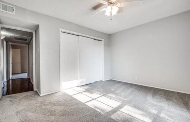 5232 Fleetwood Oaks Ave Unit 216, Dallas, TX 75235 - unfurnished bedroom with carpet, a closet, baseboards, and a ceiling fan