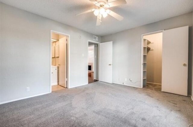 5232 Fleetwood Oaks Ave Unit 216, Dallas, TX 75235 - unfurnished bedroom with carpet flooring, a spacious closet, connected bathroom, and a closet