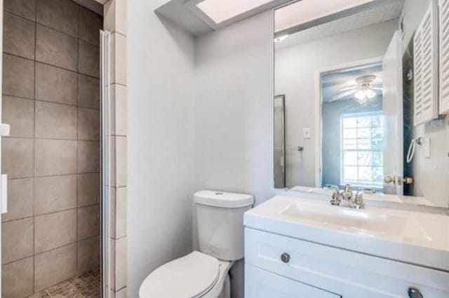 5232 Fleetwood Oaks Ave Unit 216, Dallas, TX 75235 - full bathroom with toilet, a stall shower, vanity, and a skylight
