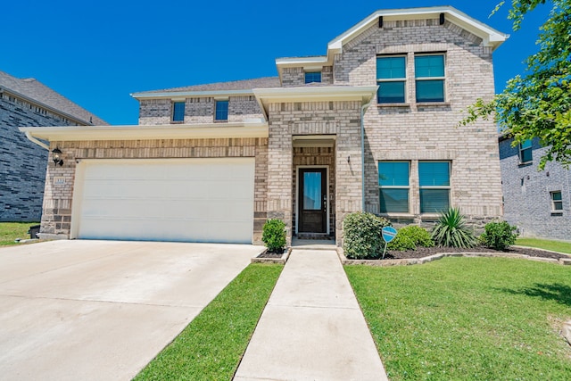 333 Mohan Dr, Royse City, TX 75189 - view of front of house featuring a front lawn, driveway, brick siding, and an attached garage
