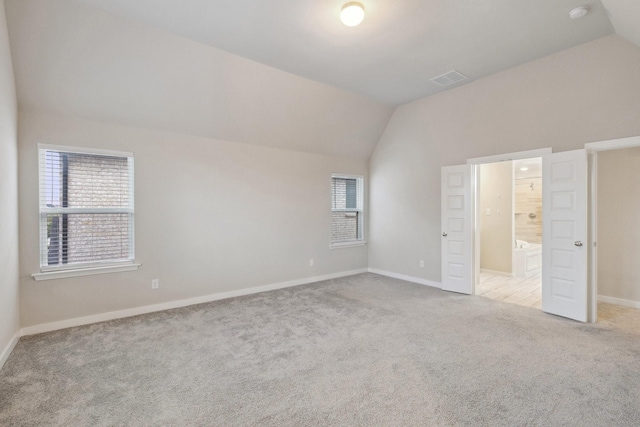3537 W Cheney Ave, Celina, TX 75009 - unfurnished bedroom featuring vaulted ceiling, carpet, multiple windows, baseboards, and ensuite bath