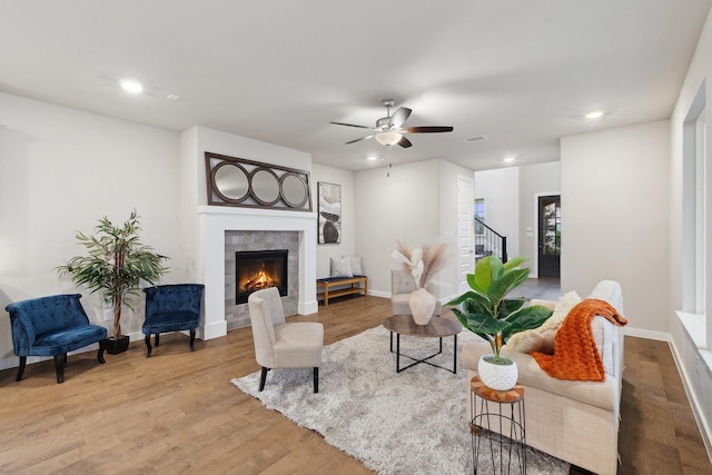 3537 W Cheney Ave, Celina, TX 75009 - living room with a tile fireplace, recessed lighting, wood finished floors, stairs, and a ceiling fan