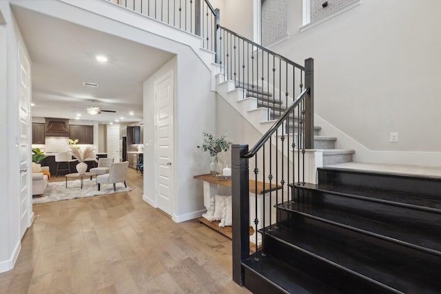 3537 W Cheney Ave, Celina, TX 75009 - stairway featuring a ceiling fan, wood finished floors, baseboards, a towering ceiling, and recessed lighting