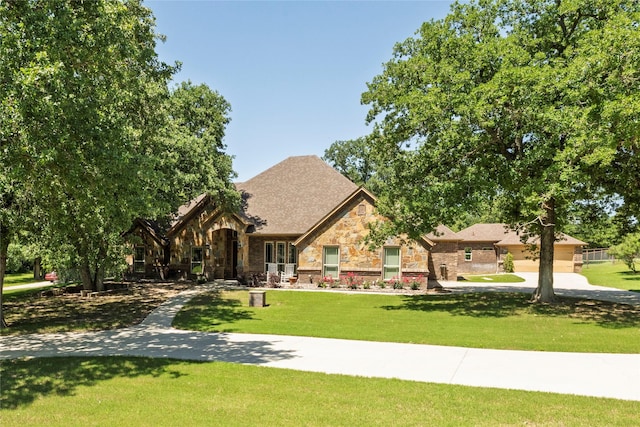 196 Ellis Creek Dr, Weatherford, TX 76085 - tudor home featuring a front yard and stone siding