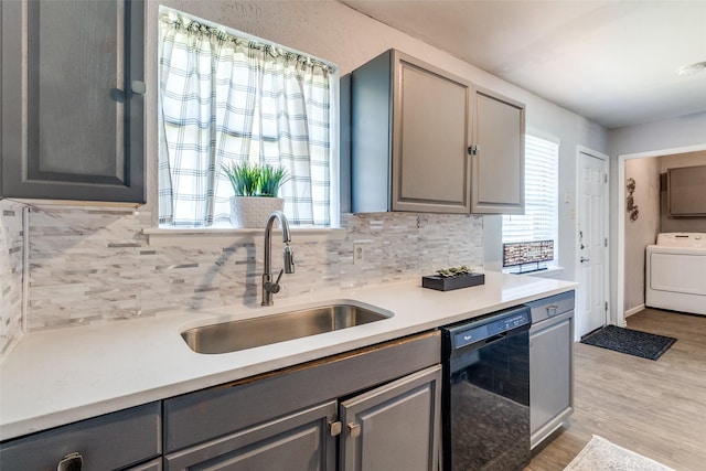 4833 Harper Dr, Mesquite, TX 75150 - kitchen with washer / clothes dryer, dishwasher, a sink, and decorative backsplash