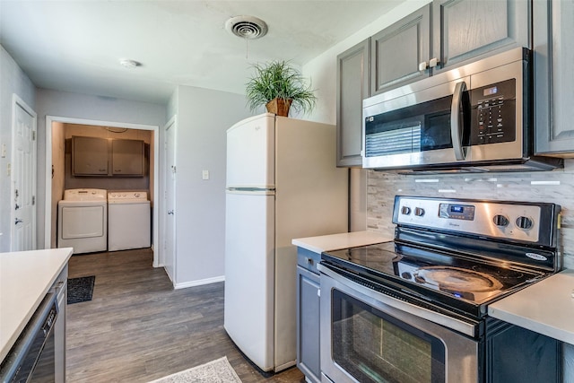 4833 Harper Dr, Mesquite, TX 75150 - kitchen featuring appliances with stainless steel finishes, independent washer and dryer, tasteful backsplash, and light countertops