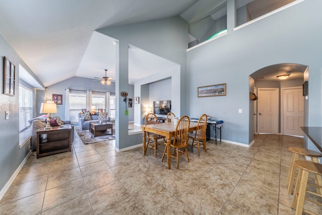 6606 Morning Dew Dr, Midlothian, TX 76065 - tiled dining area featuring arched walkways, lofted ceiling, a ceiling fan, and baseboards