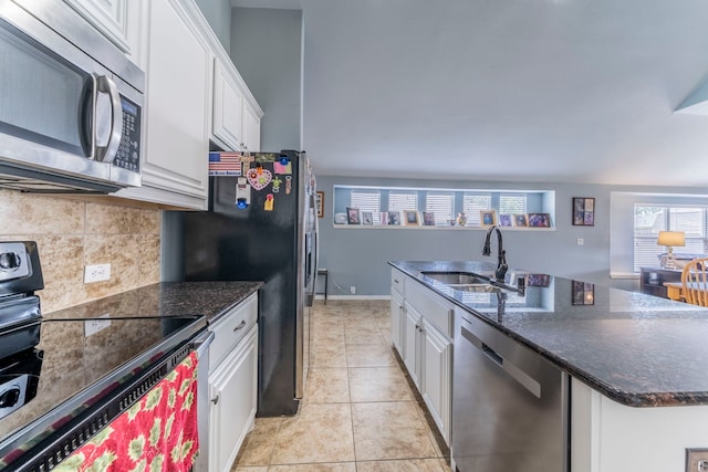 6606 Morning Dew Dr, Midlothian, TX 76065 - kitchen with appliances with stainless steel finishes, a sink, white cabinetry, and tasteful backsplash