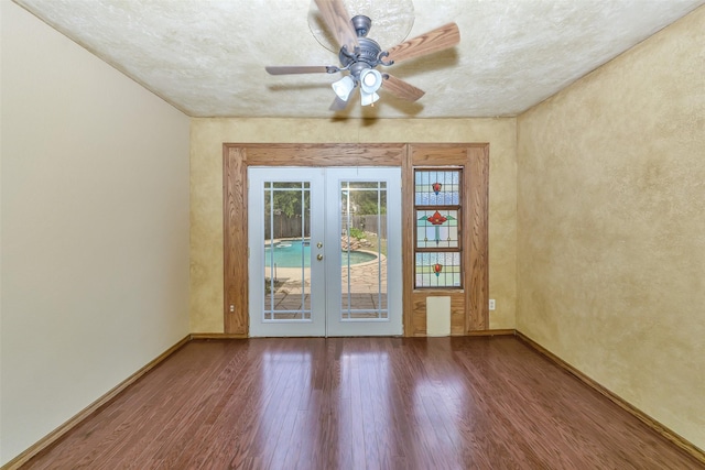unfurnished room with french doors, wood finished floors, baseboards, and a ceiling fan