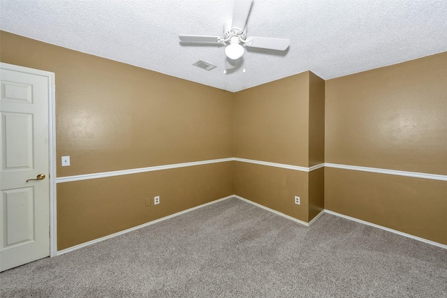 spare room featuring ceiling fan, carpet floors, a textured ceiling, and baseboards