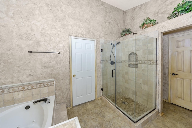 bathroom featuring a shower stall and a jetted tub