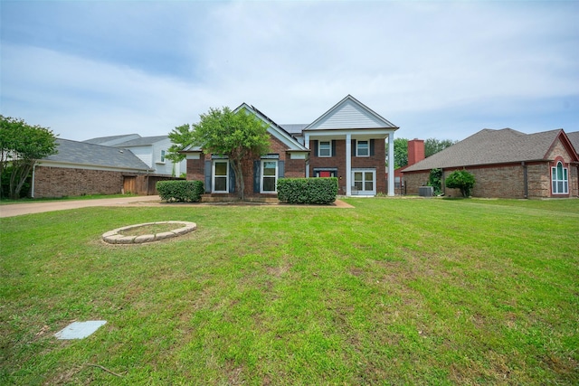 neoclassical / greek revival house featuring brick siding and a front lawn