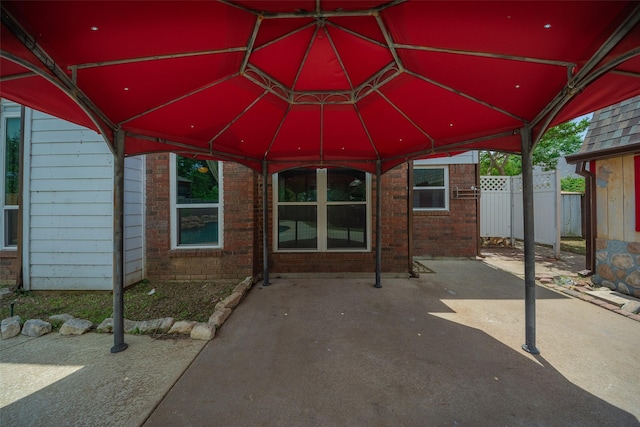 view of patio with fence and a gazebo