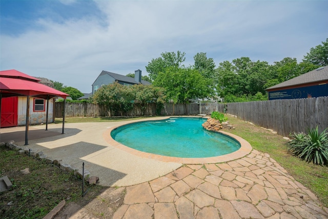 view of pool with a patio area, a fenced backyard, and a gazebo