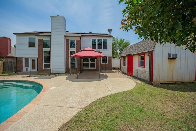 rear view of property with brick siding, a patio area, an outbuilding, a chimney, and a gazebo