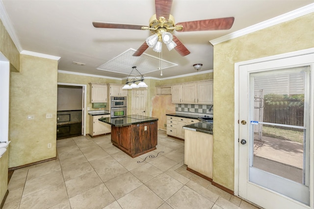 kitchen featuring dark countertops, double oven, ceiling fan, decorative backsplash, and crown molding