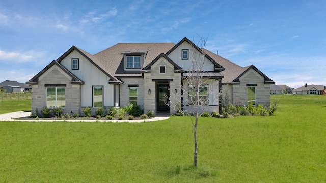 14908 S County Line Rd, Justin, TX 76247 - view of front facade with a front lawn, a shingled roof, stone siding, and board and batten siding