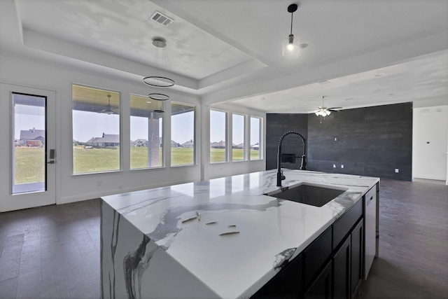 14908 S County Line Rd, Justin, TX 76247 - kitchen featuring a sink, open floor plan, a raised ceiling, light stone counters, and pendant lighting