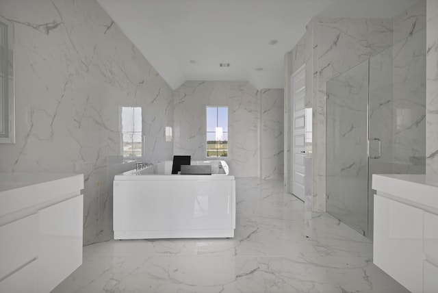 14908 S County Line Rd, Justin, TX 76247 - bathroom with stone wall, marble tiled floors, a marble finish shower, a freestanding tub, and vanity
