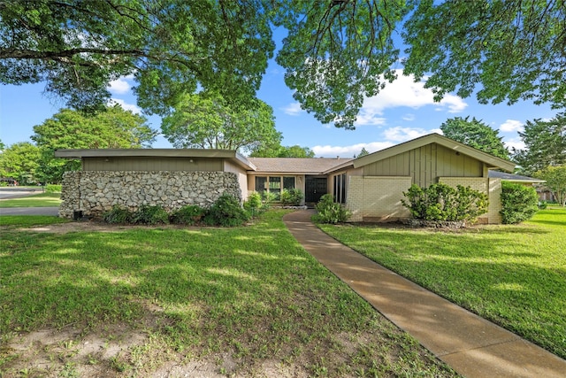 815 Middle Run, Duncanville, TX 75137 - mid-century modern home with a front lawn, brick siding, stone siding, and board and batten siding