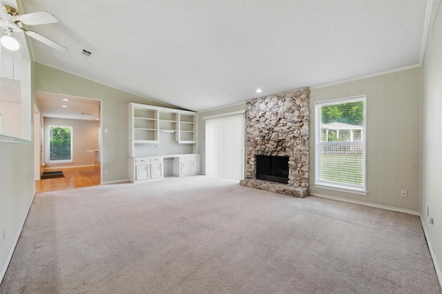 815 Middle Run, Duncanville, TX 75137 - unfurnished living room with lofted ceiling, plenty of natural light, carpet floors, a textured ceiling, and a ceiling fan