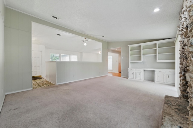 815 Middle Run, Duncanville, TX 75137 - unfurnished living room featuring ornamental molding, light colored carpet, a textured ceiling, baseboards, and wood walls