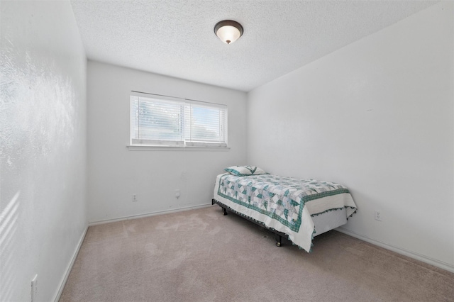 815 Middle Run, Duncanville, TX 75137 - carpeted bedroom with a textured ceiling and baseboards