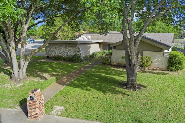 815 Middle Run, Duncanville, TX 75137 - view of front facade with a front yard, brick siding, and a shingled roof