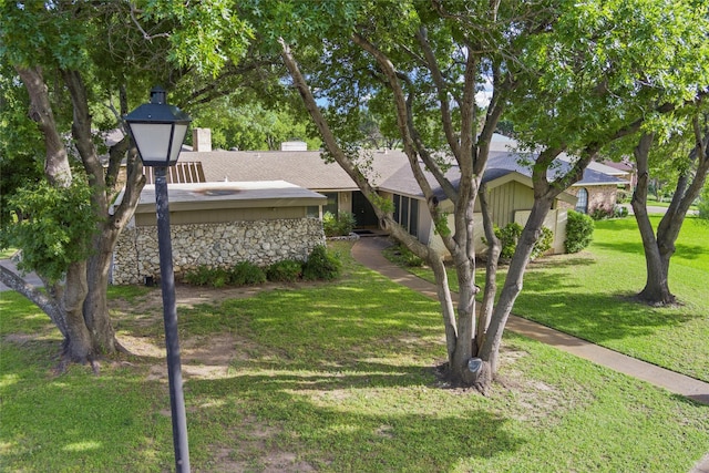 815 Middle Run, Duncanville, TX 75137 - view of front of property featuring stone siding, a front lawn, and roof with shingles