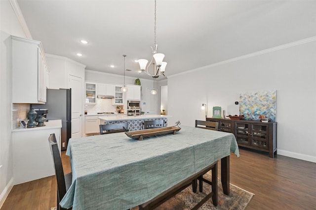 7205 York St, North Richland Hills, TX 76180 - dining space with a chandelier, baseboards, dark wood-style flooring, recessed lighting, and crown molding