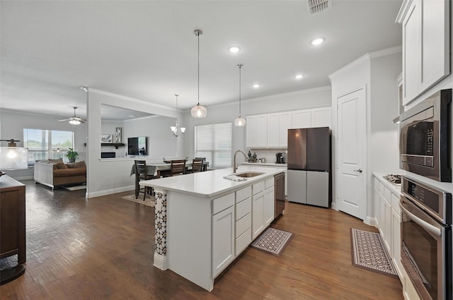 7205 York St, North Richland Hills, TX 76180 - kitchen with stainless steel appliances, a sink, light countertops, open floor plan, and white cabinetry