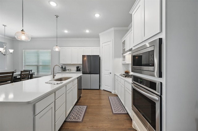 7205 York St, North Richland Hills, TX 76180 - kitchen featuring appliances with stainless steel finishes, a sink, crown molding, light countertops, and white cabinets