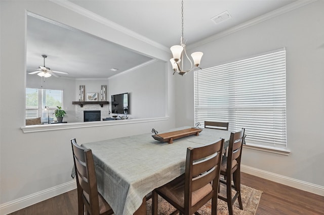 7205 York St, North Richland Hills, TX 76180 - dining space with baseboards, dark wood-style floors, a fireplace, a chandelier, and ornamental molding