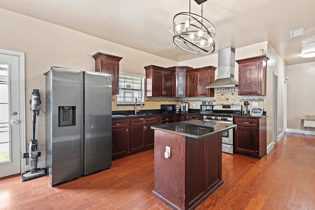 522 Helena St, Dallas, TX 75217 - kitchen with appliances with stainless steel finishes, wall chimney range hood, a sink, dark wood-style flooring, and backsplash
