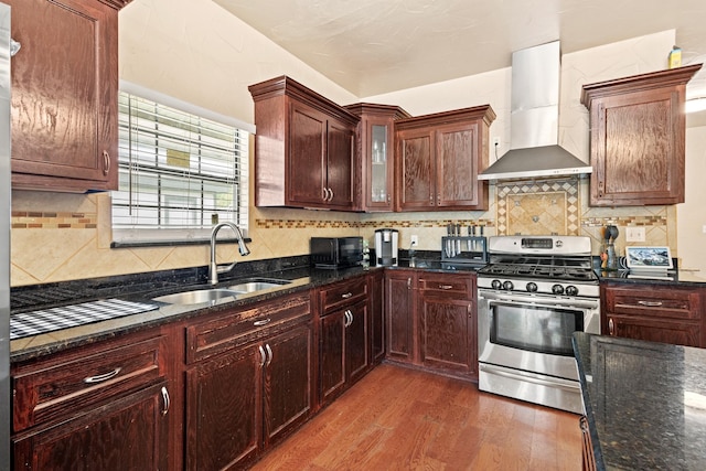 522 Helena St, Dallas, TX 75217 - kitchen with gas stove, wall chimney range hood, wood finished floors, a sink, and dark stone counters