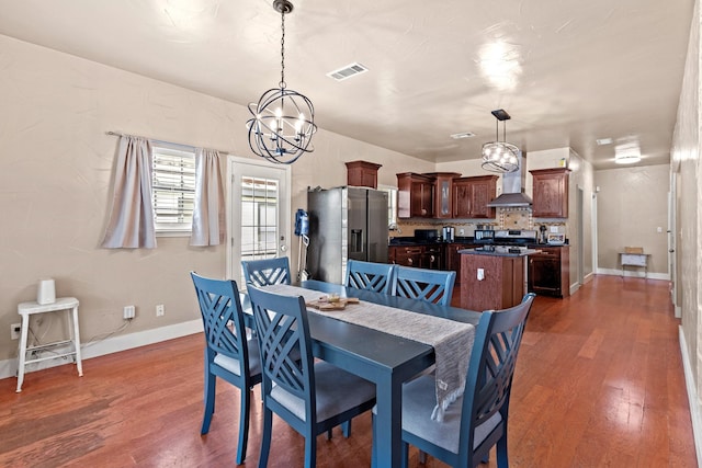 522 Helena St, Dallas, TX 75217 - dining area featuring a chandelier, dark wood-type flooring, and baseboards