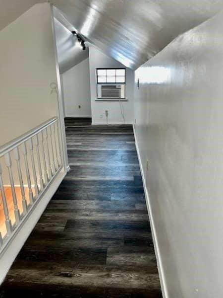 522 Helena St, Dallas, TX 75217 - hall featuring lofted ceiling, dark wood-style floors, cooling unit, and baseboards