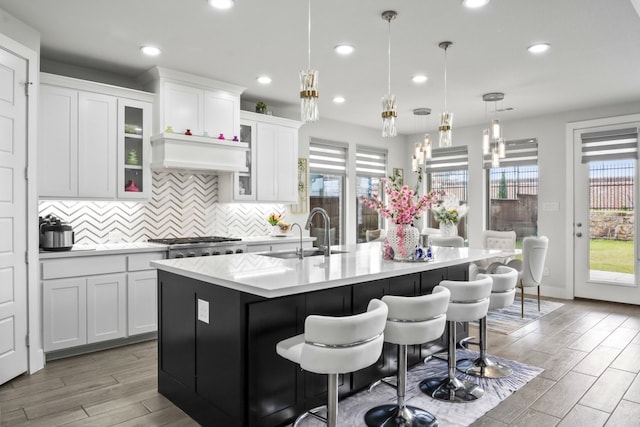 2229 Boboli Ct, Celina, TX 75009 - kitchen with a sink, healthy amount of natural light, a center island with sink, light countertops, and recessed lighting