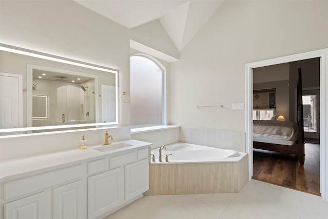 2671 Marshall Dr, Frisco, TX 75033 - ensuite bathroom featuring a stall shower, vanity, a bath, vaulted ceiling, and tile patterned flooring