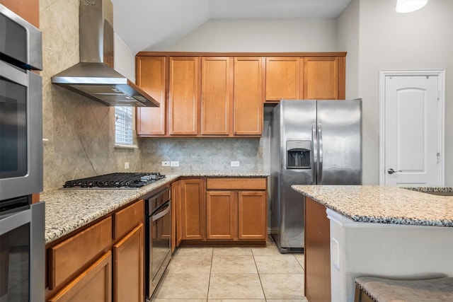 6620 Roaring Crk, Denton, TX 76226 - kitchen featuring wall chimney exhaust hood, appliances with stainless steel finishes, backsplash, lofted ceiling, and light stone countertops