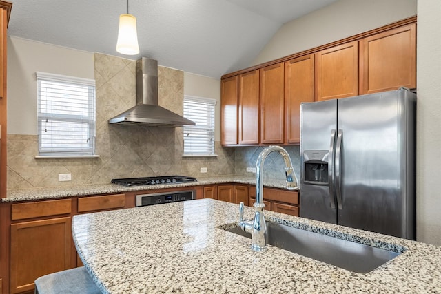 6620 Roaring Crk, Denton, TX 76226 - kitchen with appliances with stainless steel finishes, wall chimney exhaust hood, a sink, decorative backsplash, and brown cabinetry