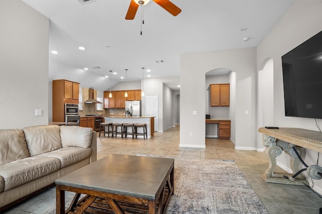 6620 Roaring Crk, Denton, TX 76226 - living area featuring a ceiling fan, arched walkways, vaulted ceiling, baseboards, and light tile patterned floors