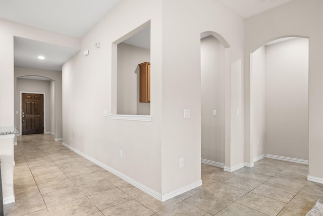 6620 Roaring Crk, Denton, TX 76226 - hallway featuring arched walkways, recessed lighting, light tile patterned floors, and baseboards
