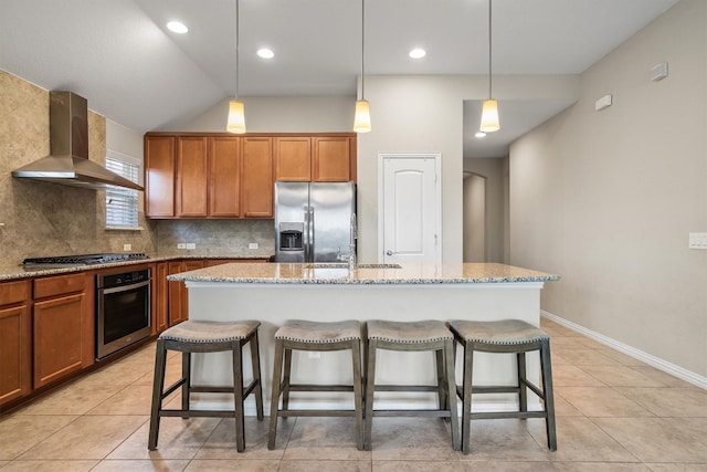 6620 Roaring Crk, Denton, TX 76226 - kitchen featuring appliances with stainless steel finishes, wall chimney exhaust hood, a sink, a breakfast bar area, and tasteful backsplash