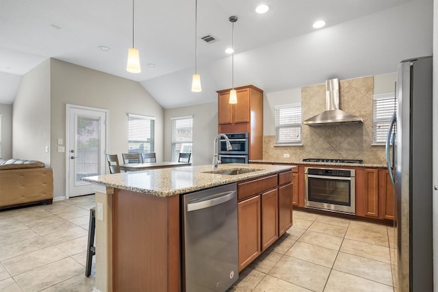 6620 Roaring Crk, Denton, TX 76226 - kitchen with appliances with stainless steel finishes, wall chimney exhaust hood, light tile patterned floors, lofted ceiling, and backsplash