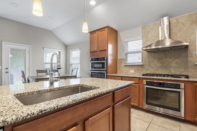 6620 Roaring Crk, Denton, TX 76226 - kitchen with a sink, wall chimney range hood, brown cabinets, appliances with stainless steel finishes, and lofted ceiling