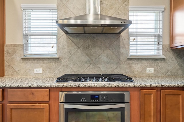 6620 Roaring Crk, Denton, TX 76226 - kitchen featuring appliances with stainless steel finishes, range hood, and decorative backsplash